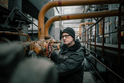 Rear view of man working in factory