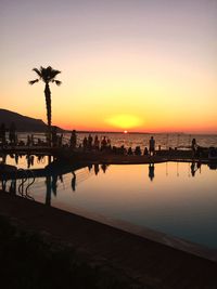 Silhouette of swimming pool at beach during sunset