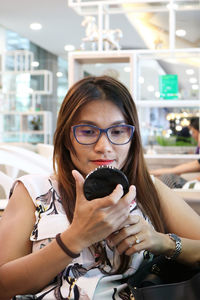Portrait of young woman using mobile phone