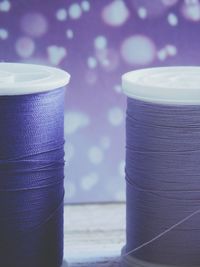 Close-up of purple spools on table