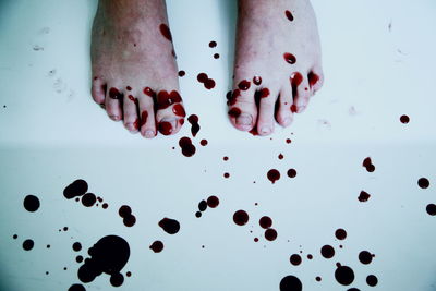 Low section of person with blood on floor