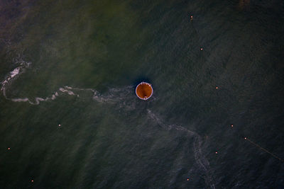 High angle view of hot air balloons in sea