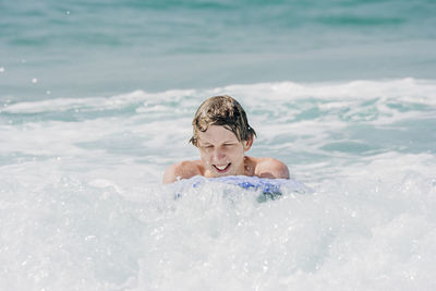 Young man on surfboard in sea