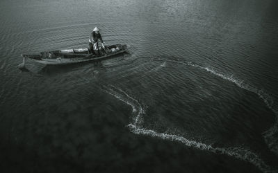 High angle view of men sailing on sea