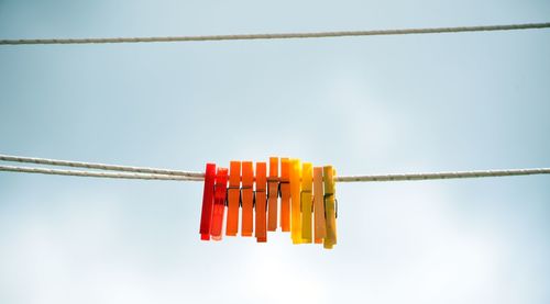 Low angle view of red flags against sky