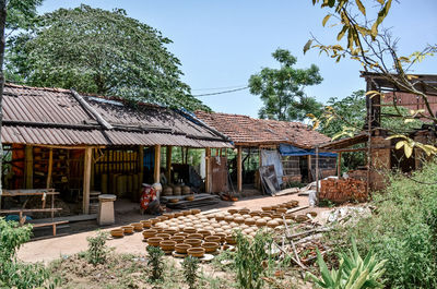 House in village against clear sky