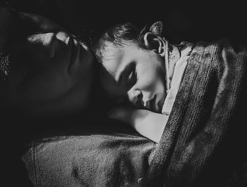 Portrait of man sleeping on bed