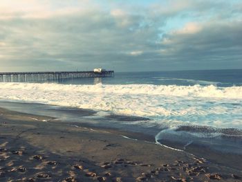 Scenic view of sea against cloudy sky