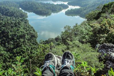 Low section of man sitting on mountain