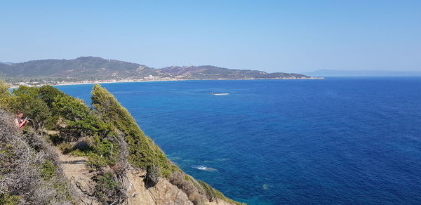 Scenic view of sea against clear blue sky