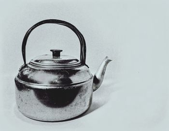 Close-up of tea cup on table against white background