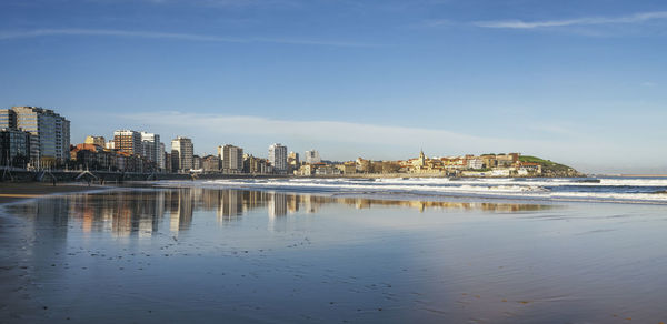 Scenic view of sea and buildings against sky
