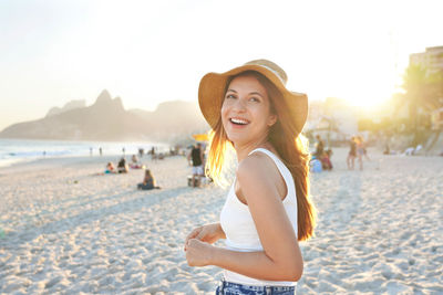 Portrait of young woman sitting on beach