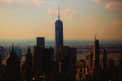 Skyscrapers in city at sunset