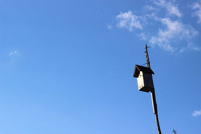 Low angle view of pole against blue sky