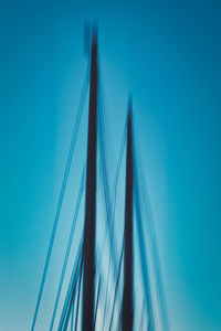 Low angle view of sailboat against blue sky