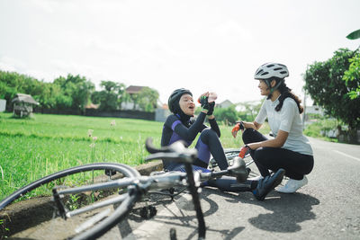 Side view of man riding bicycle on field