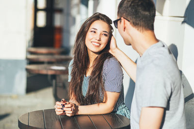 Portrait of smiling young woman using mobile phone