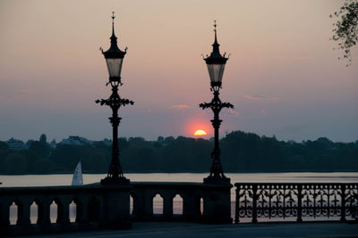 View of street lights against sky during sunset