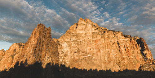 Low angle view of rock formation against sky