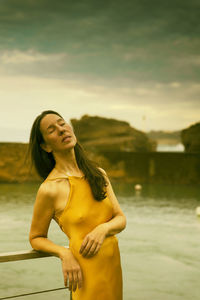 Woman with yellow dress on the basque-french coast iii