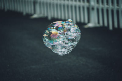 Close-up of bubbles over street