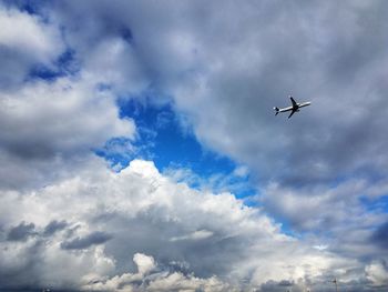 Low angle view of airplane flying in sky