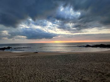 Scenic view of beach against sky during sunset