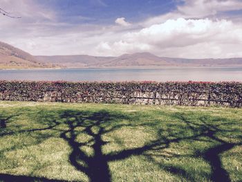 Scenic view of mountains against cloudy sky