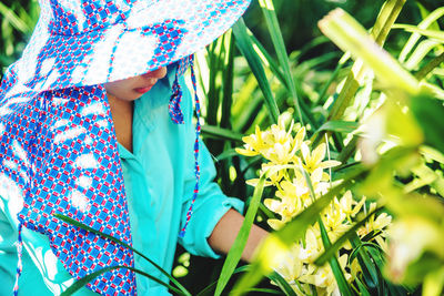 Midsection of woman holding flowering plant