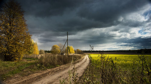 Scenic view of field against storm clouds