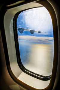 Scenic view of sea seen through airplane window