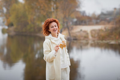 Happy redhair woman in white clothes