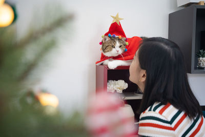 Rear view of woman with christmas tree