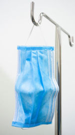 Close-up of clothes hanging on metal against white background