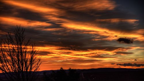 Silhouette of landscape against cloudy sky