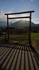 Wooden posts on soccer field against sky