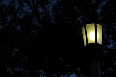 Low angle view of lamp post at night