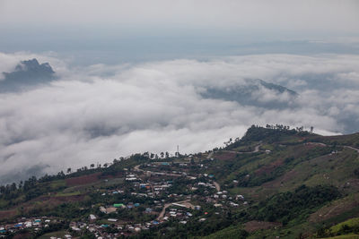 Aerial view of townscape and mountains against sky