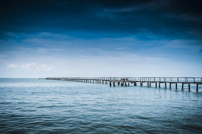 Tranquil view of pier at sea against sky