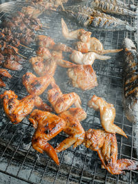 High angle view of meat on barbecue grill