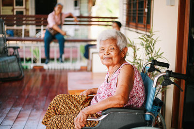 Side view of young woman sitting on chair