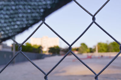 Close-up of chainlink fence against sky