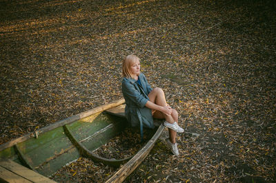 Rear view of woman sitting in park