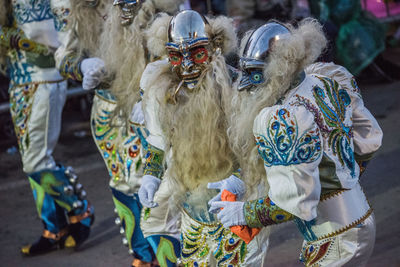 High angle view of people wearing costumes dancing on street