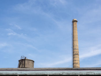 Low angle view of smoke stack against sky