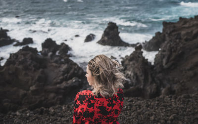 Woman standing on rock at beach