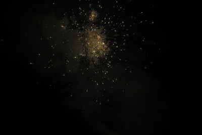 Low angle view of firework display at night