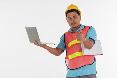 Low angle view of man using mobile phone against white background