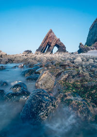 View of rock formations against blue sky